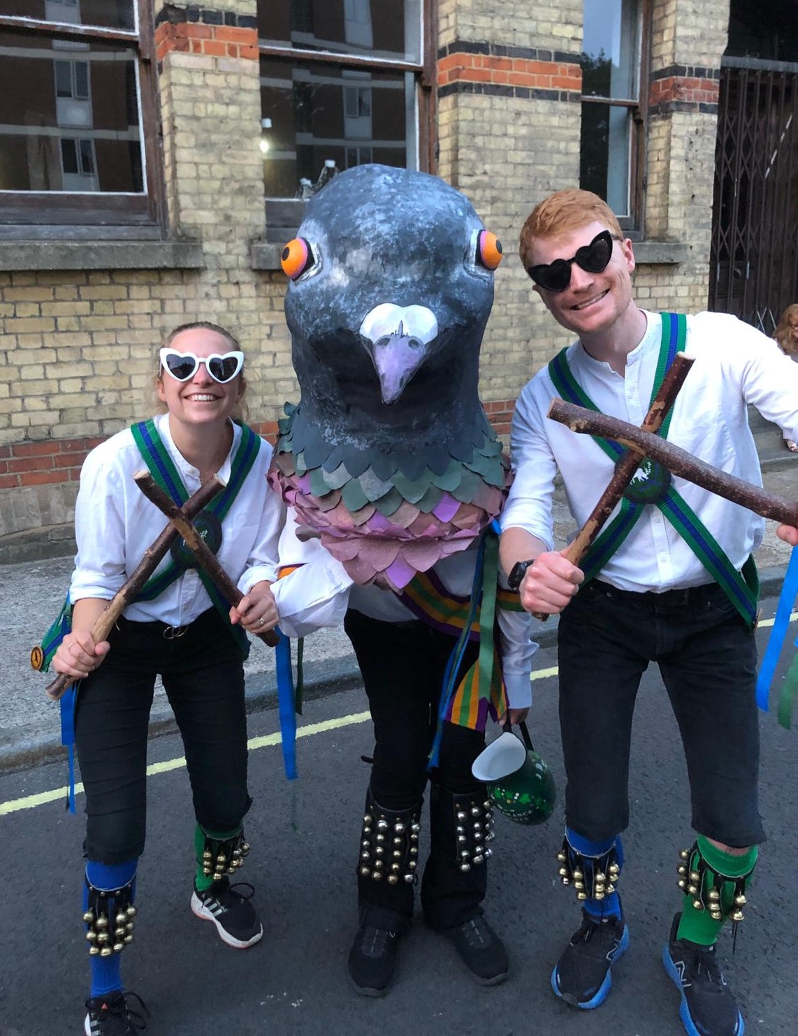 Two Quaggy Morris members with a person disguised as a pigeon